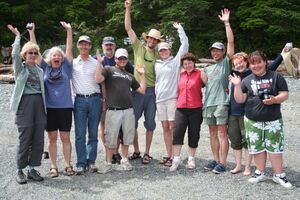 Happy kayaking group waving on Spring Island beach