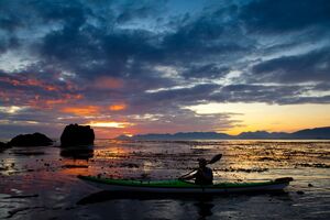 sea kayaker with sunset in Kyuquot, BC
