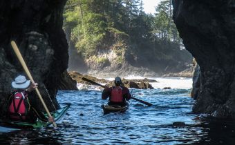 kayaking through a sea arch
