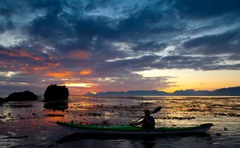 sea kayaker with sunset in Kyuquot, BC