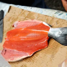 butterflied salmon being prepared for the fire